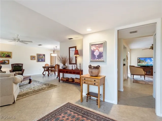 a living room with furniture a rug and a table