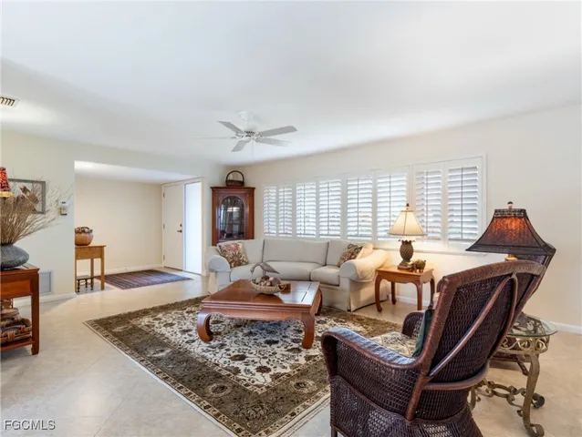 a living room with furniture rug and window
