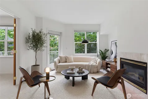 a living room with furniture and a potted plant
