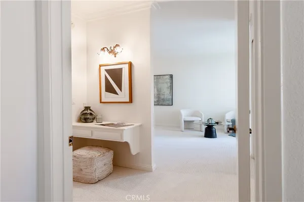 a view of hallway with table and mirror