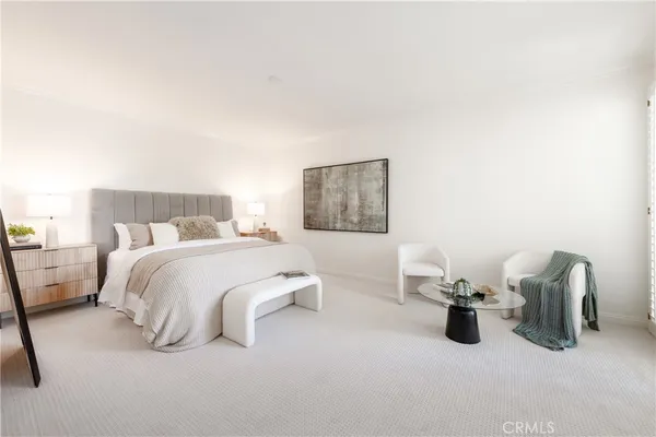 a bedroom with a large bed and a large window