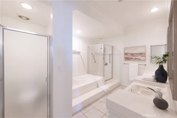 a bathroom with a double vanity sink toilet and shower