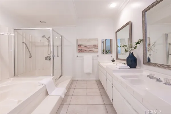 a bathroom with double vanity sinks and a mirror