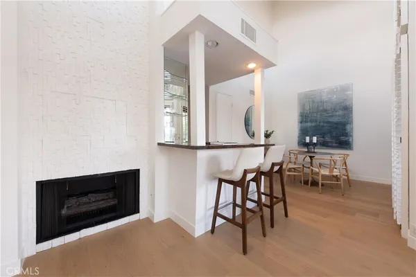 a living room with furniture a rug and a wall painting