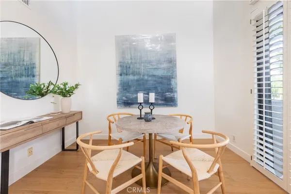 a view of a dining room with furniture and a potted plant