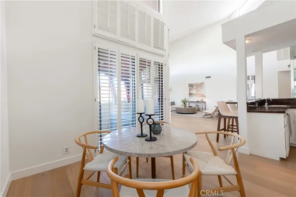 a dining room with furniture and wooden floor