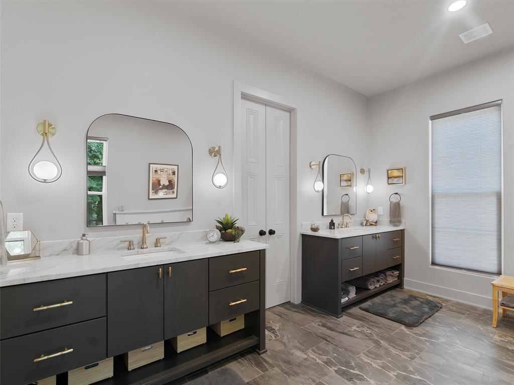 800 John Dean Road Gilmer, TX 75644 - Photo 24 of 40 a en suite bathroom with a double vanity sink and a mirror