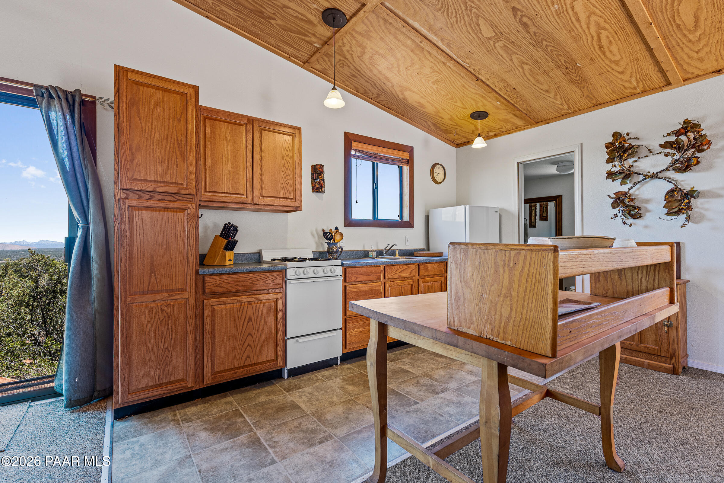 33749 West Whiskey River Road, Unit 21 Seligman, AZ 86337 - Photo 13 of 41 a view of kitchen with granite countertop cabinets and flat screen tv