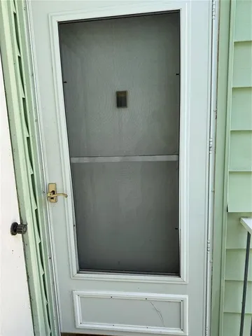 a view of hallway with furniture and a window