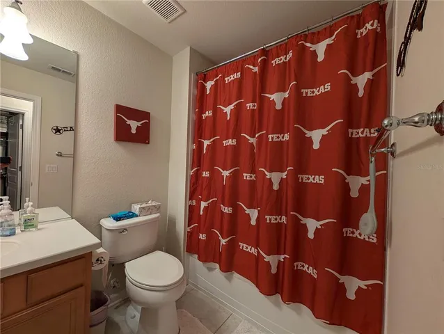 a white toilet sitting next to a bathroom sink