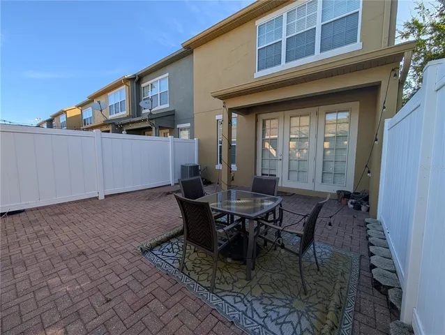 a view of a house with backyard and sitting area