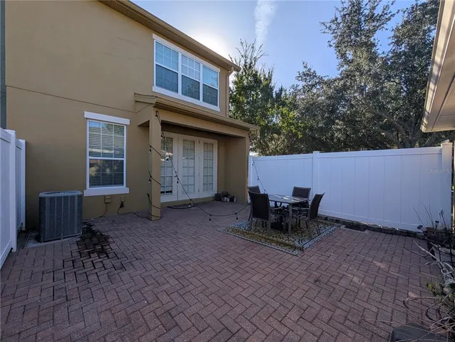 a backyard of a house with table and chairs