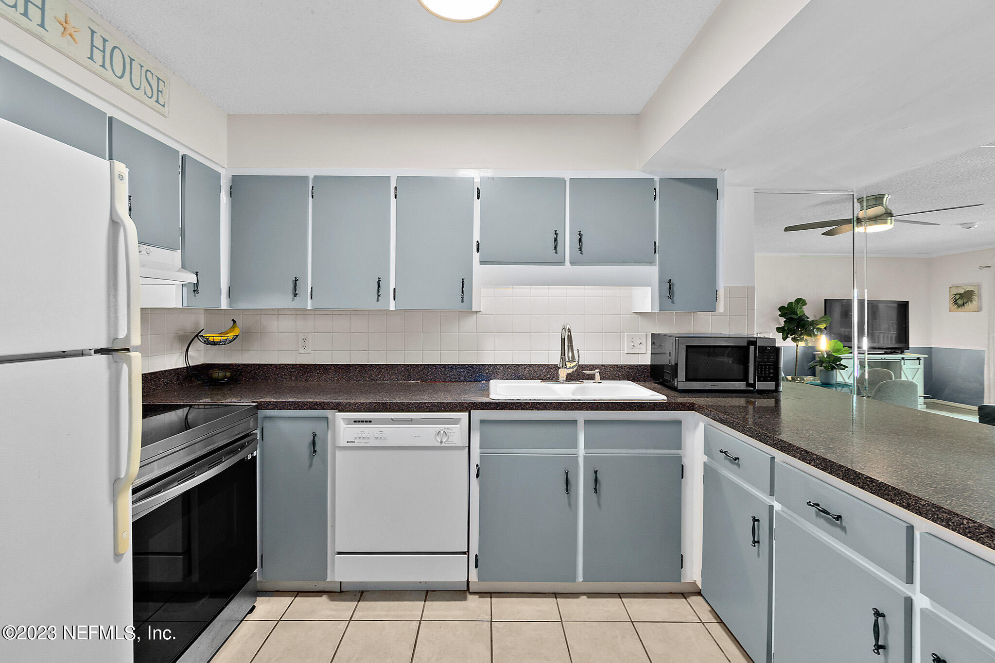 1 Ocean Trace Road, Unit 242 St. Augustine, FL 32080 - Photo 16 of 42 a kitchen with stainless steel appliances granite countertop a sink stove and refrigerator