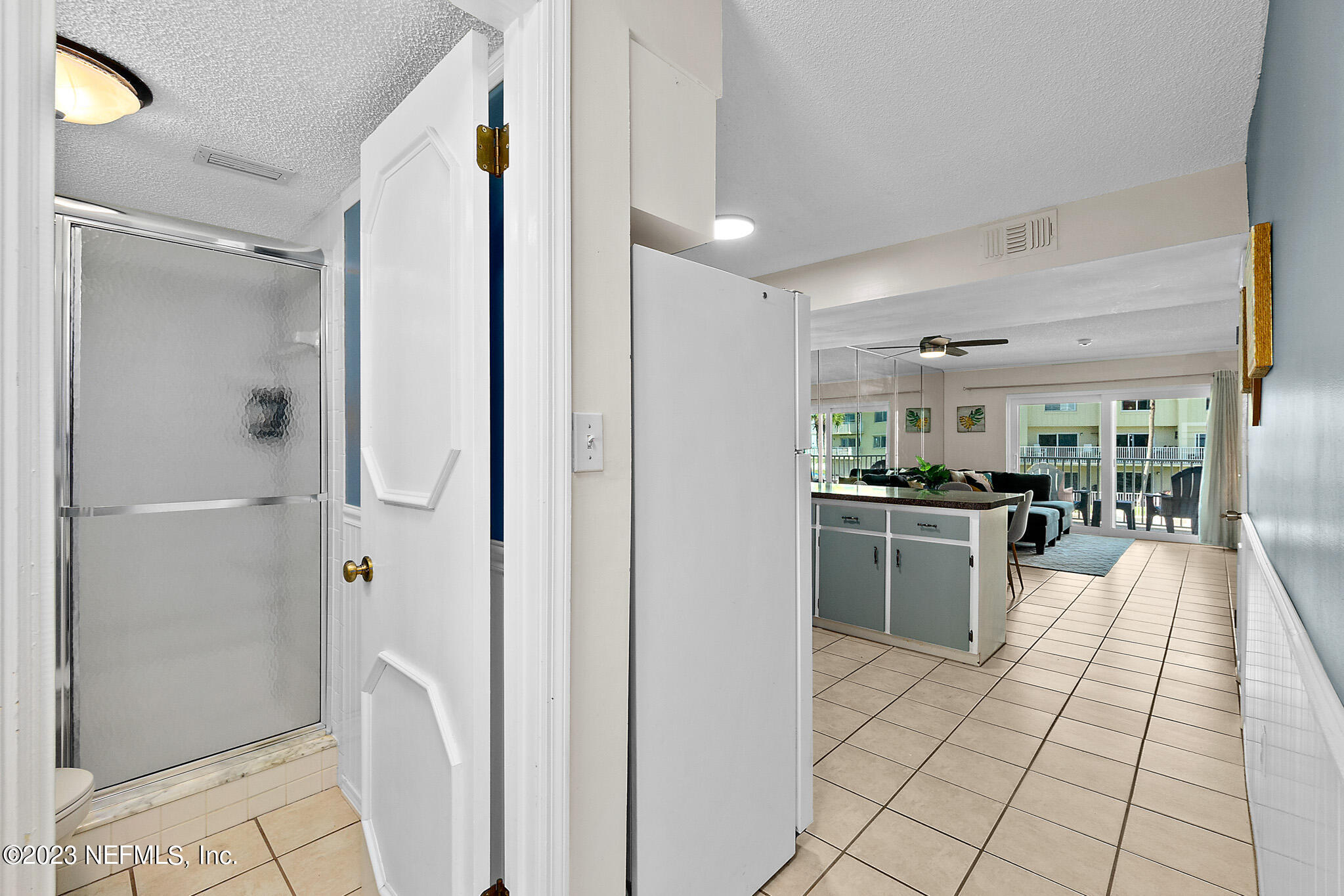 1 Ocean Trace Road, Unit 242 St. Augustine, FL 32080 - Photo 19 of 42 a large white kitchen with a sink and refrigerator