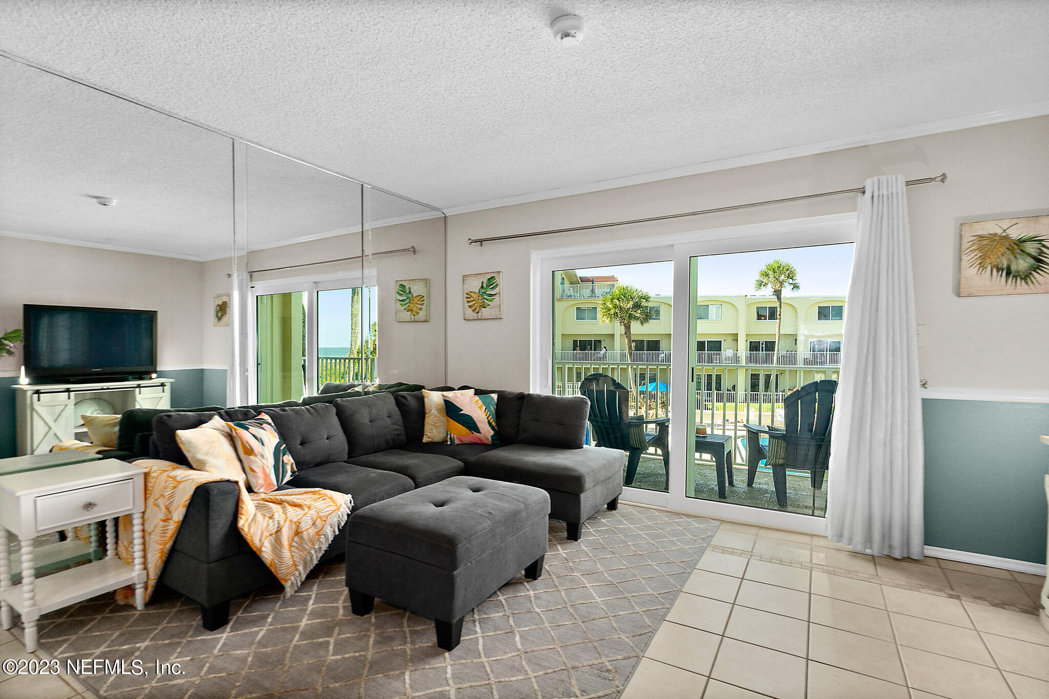 1 Ocean Trace Road, Unit 242 St. Augustine, FL 32080 - Photo 5 of 42 a living room with furniture and a flat screen tv