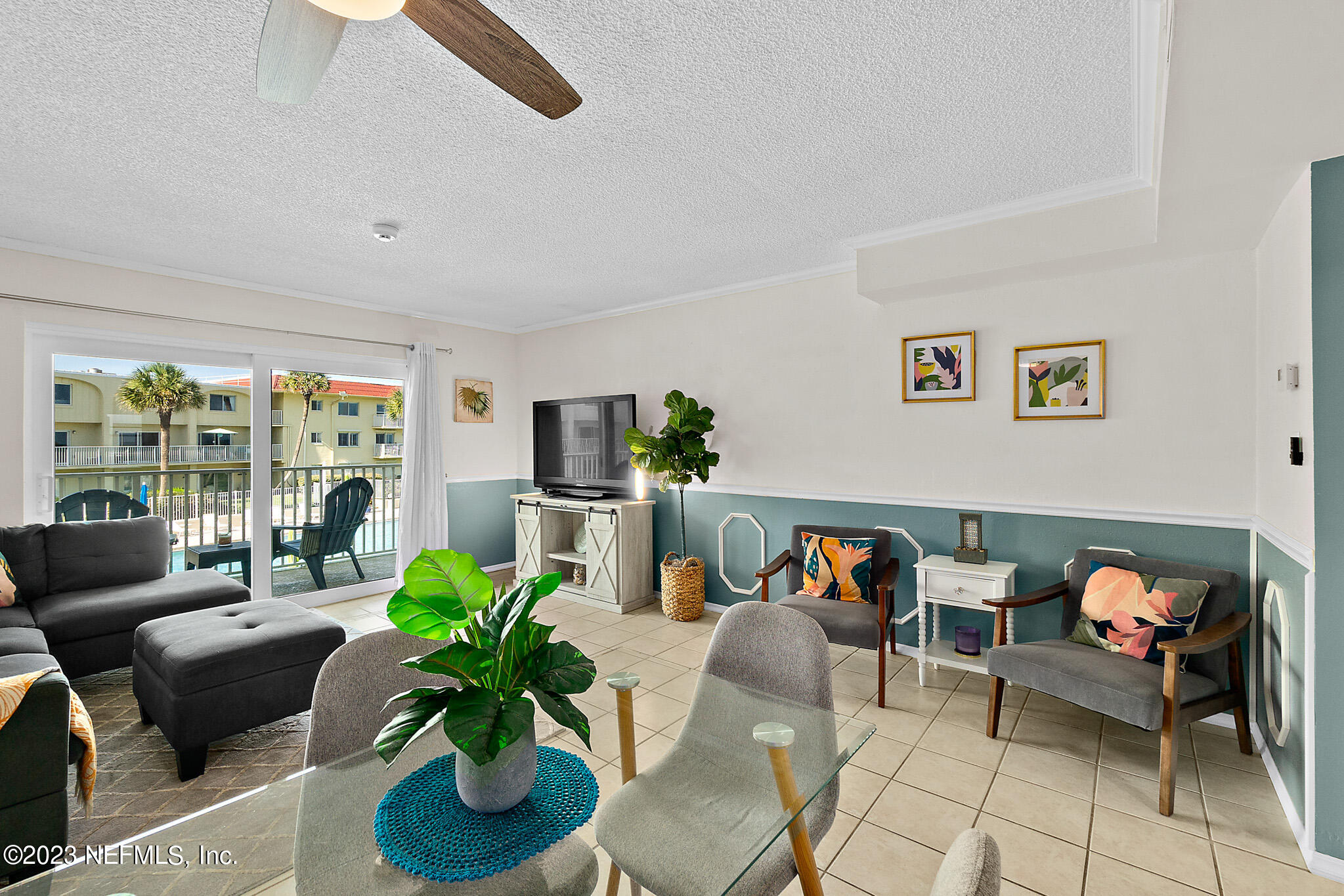 1 Ocean Trace Road, Unit 242 St. Augustine, FL 32080 - Photo 6 of 42 a living room with furniture floor to ceiling window and a potted plant