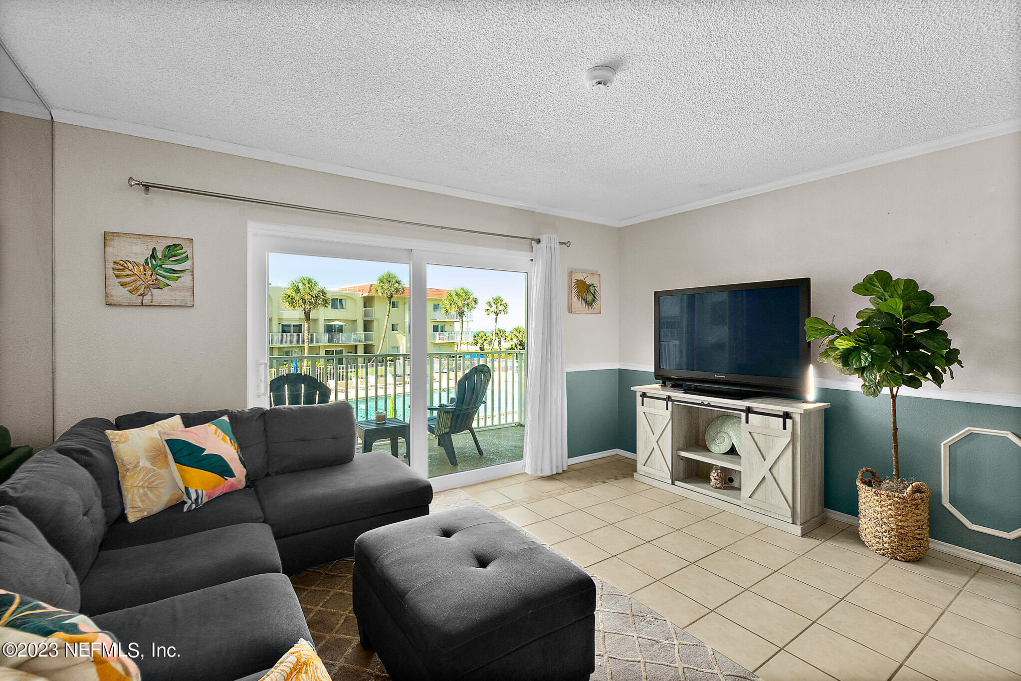 1 Ocean Trace Road, Unit 242 St. Augustine, FL 32080 - Photo 7 of 42 a bedroom with furniture and a flat screen tv