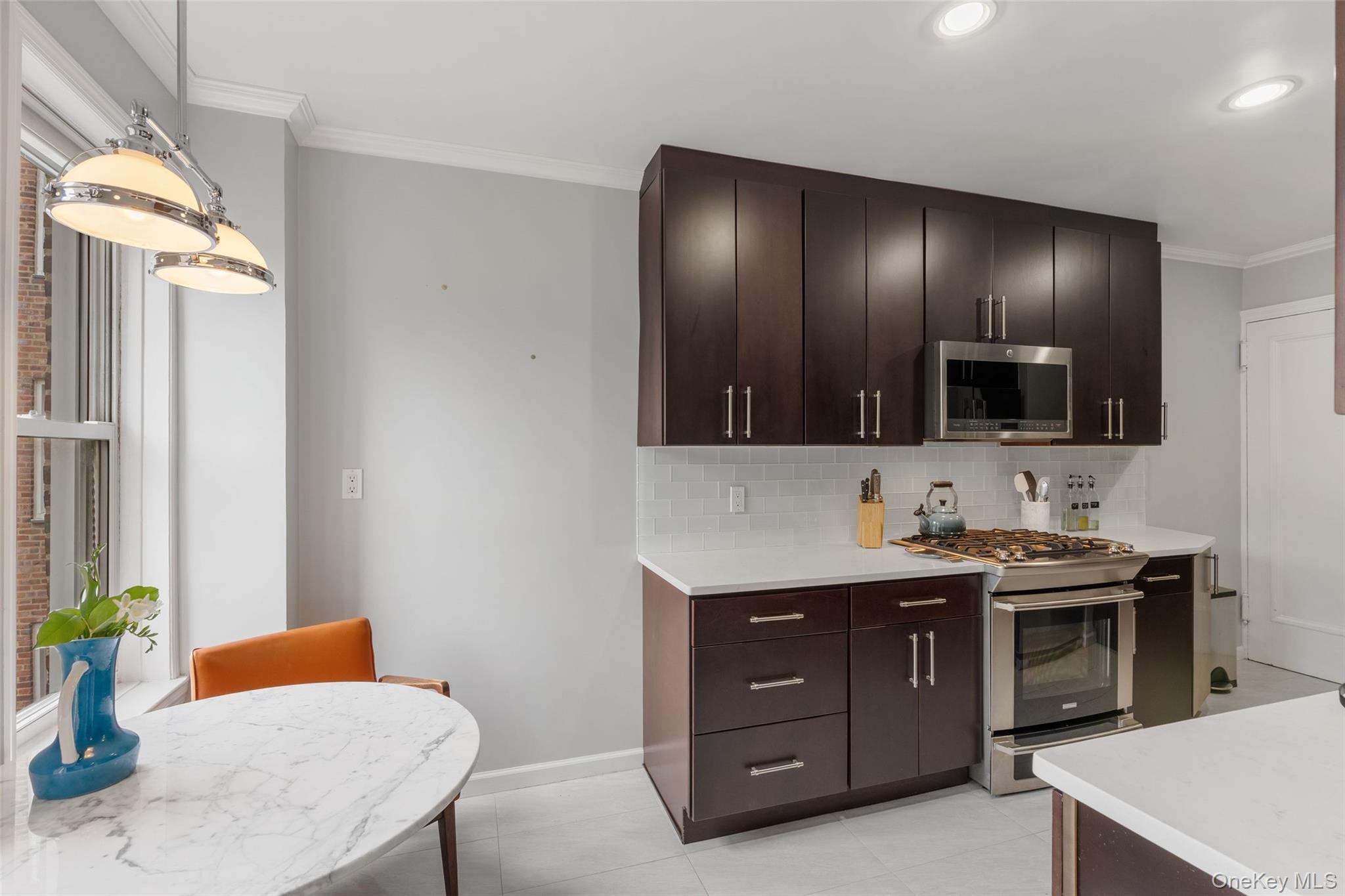 280 Bronxville Road, Unit 8B Bronxville, NY 10708 - Photo 5 of 14 Beautifully appointed Dine-In Kitchen with wood cabinetry, Sandstone countertops and glass back splash.