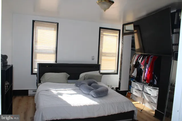 a bedroom with a bed and a flat tv screen