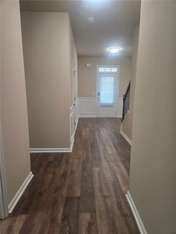 a view of hallway with wooden floor