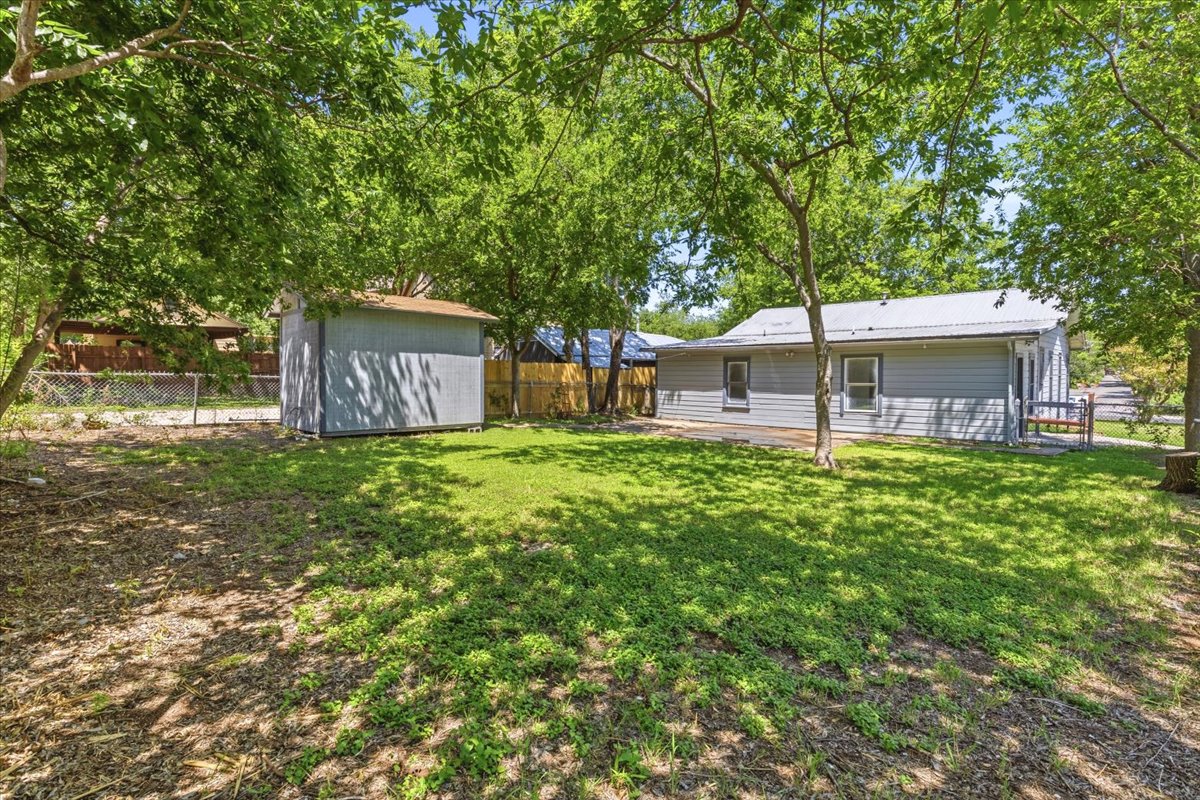 4900 Duval Street Austin, TX 78751 - Photo 9 of 25 Corner-lot property in Central Austin’s 78751 with alley access, SF-3 zoning, and a flexible existing layout. The home includes a main residence plus an attached rear apartment/flex space with separate exterior access and shared utility/laundry area, creating a compelling opportunity to renovate, reimagine, or explore redevelopment potential. Buyer to verify zoning, permits, use, and development options.