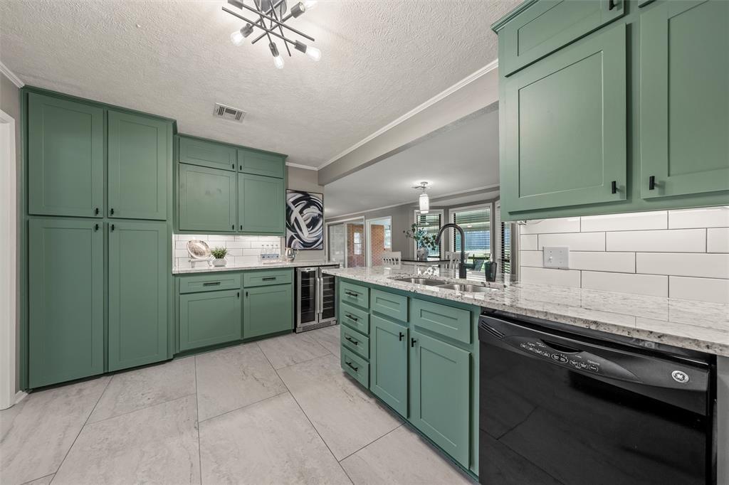 3924 North 30th Street Waco, TX 76708 - Photo 13 of 33 Kitchen featuring green cabinetry, light-toned tile flooring, granite countertops, subway tile backsplash, and a built-in beverage cooler