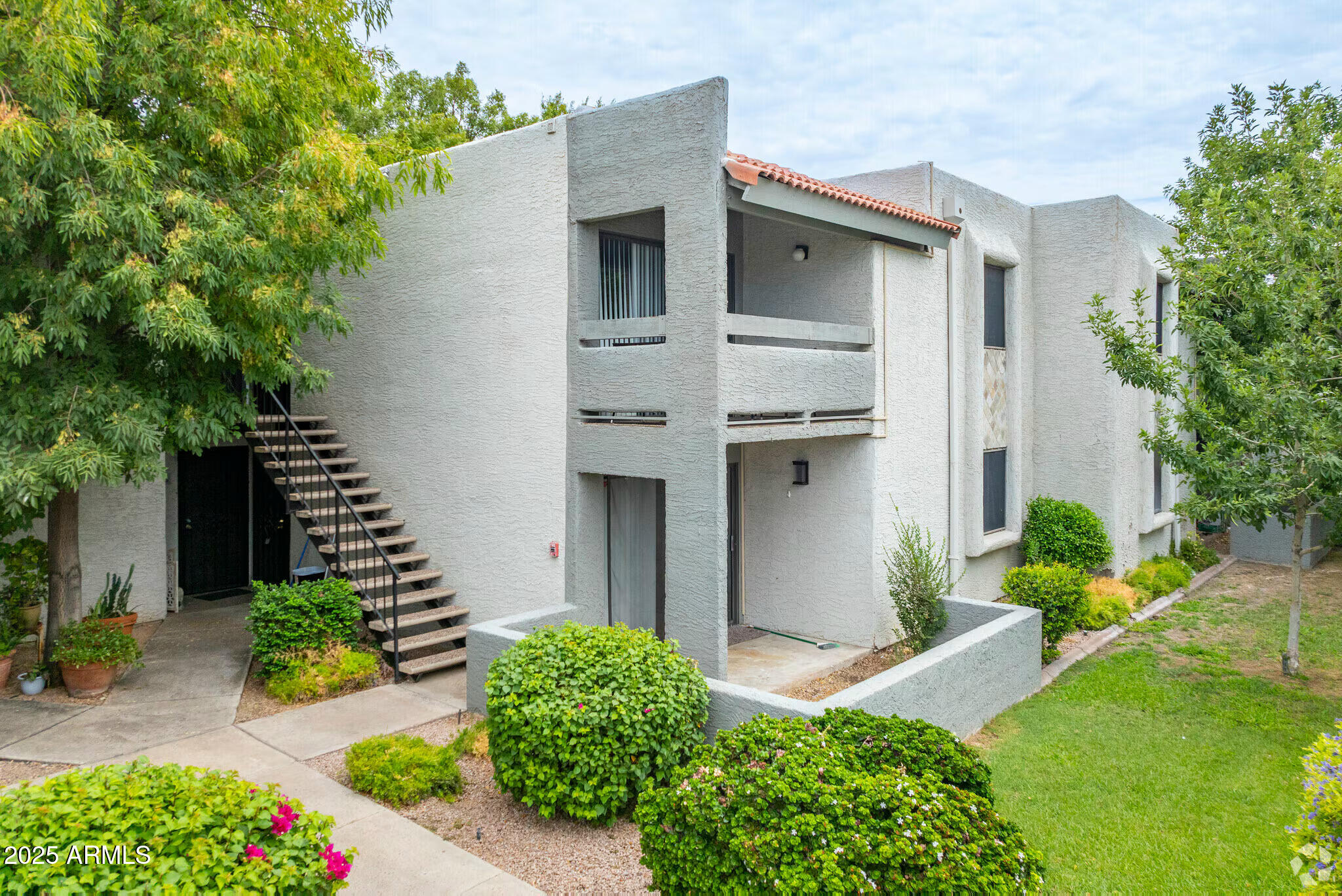 6505 East Osborn Road, Unit 21 Scottsdale, AZ 85251 - Photo 1 of 9 a front view of a house with garden