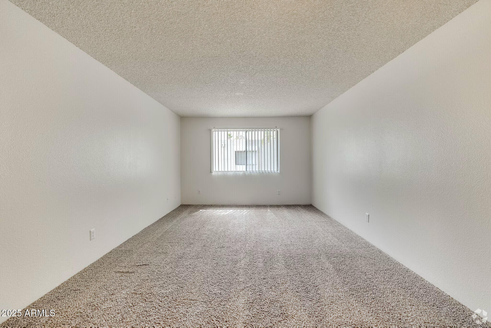 6505 East Osborn Road, Unit 21 Scottsdale, AZ 85251 - Photo 2 of 9 an empty room with windows