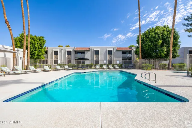 a swimming pool with outdoor seating and yard