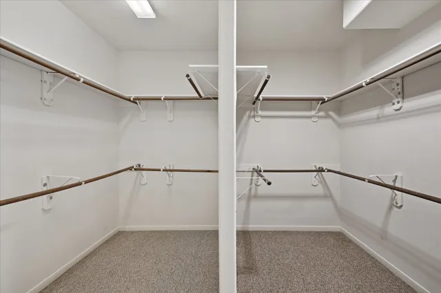 a view of walk in closet with empty racks