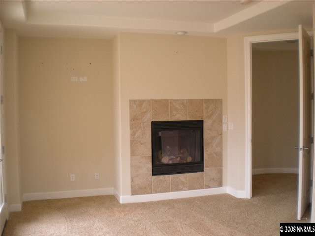 10010 Burghley Lane Reno, NV 89521 - Photo 8 of 9 a view of an empty room with a fireplace