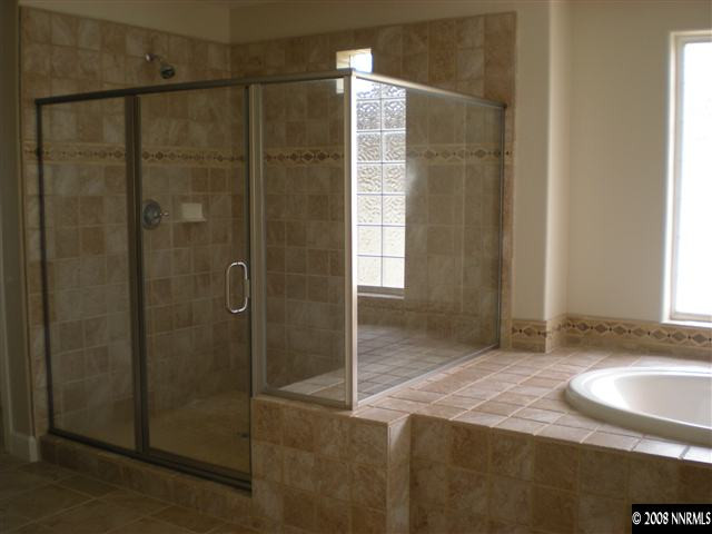 10010 Burghley Lane Reno, NV 89521 - Photo 9 of 9 a bathroom with a granite countertop sink and shower