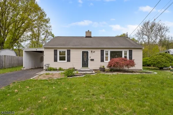 a front view of a house with a garden and yard
