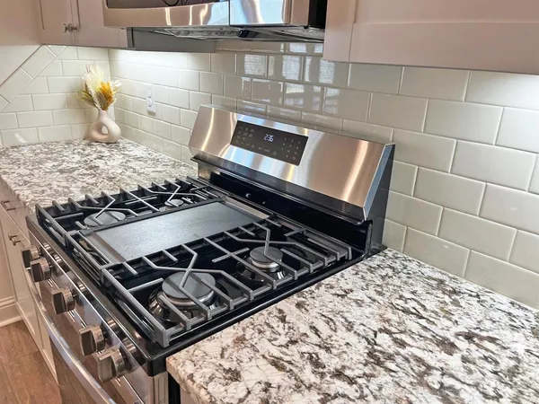 a stove sitting inside of a kitchen