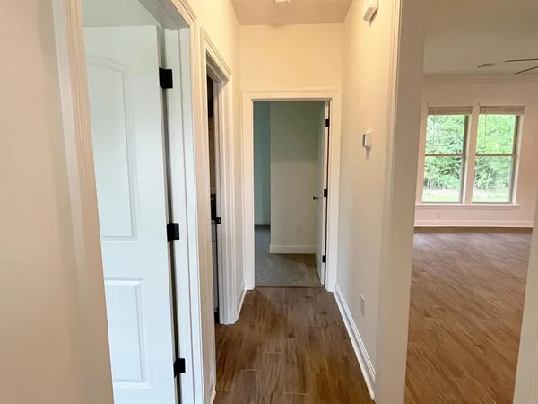 a view of a hallway with wooden floor