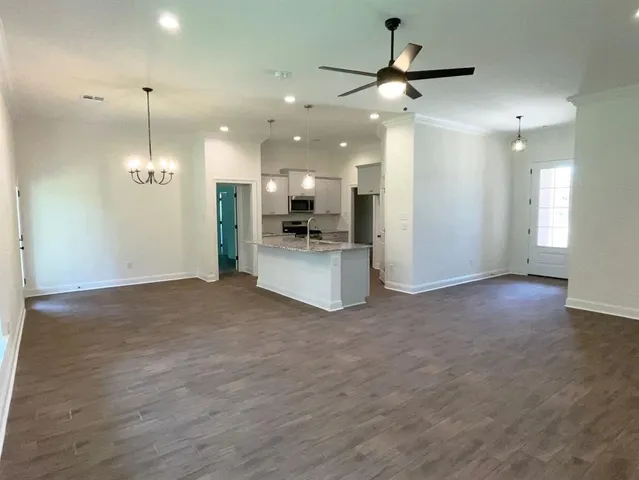 a view of a kitchen with a sink and a refrigerator
