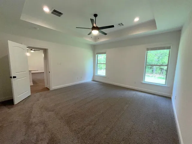 an empty room with windows and entrance