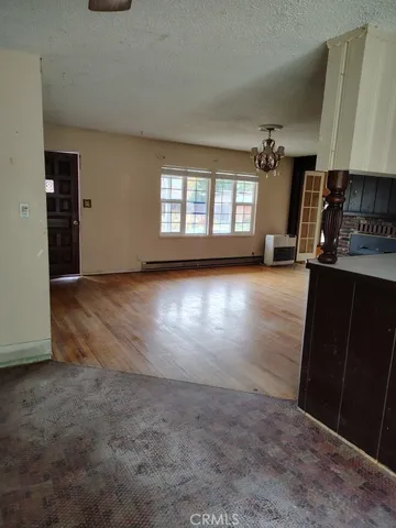 an empty room with closet and windows