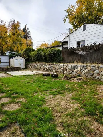 a front view of a house with garden and lake view