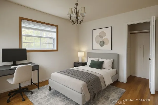 a bedroom with a bed and a desk