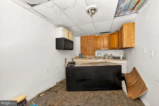 a view of kitchen with stainless steel appliances granite countertop a sink and a stove
