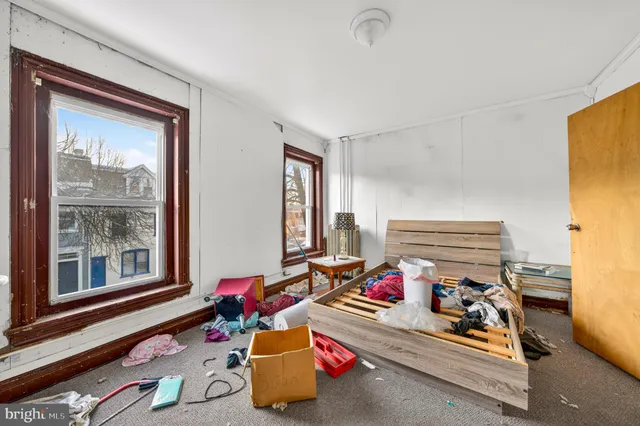 a bedroom with furniture and a window