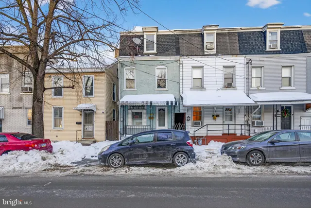 a car parked in front of a white building