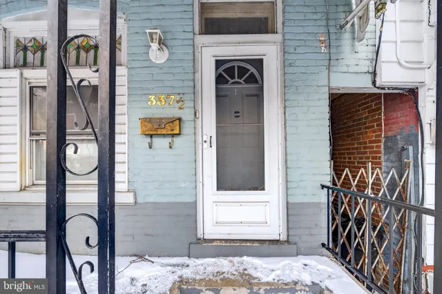 a brick building with a door and a window
