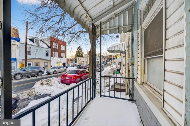 a view of a street with cars parked on road