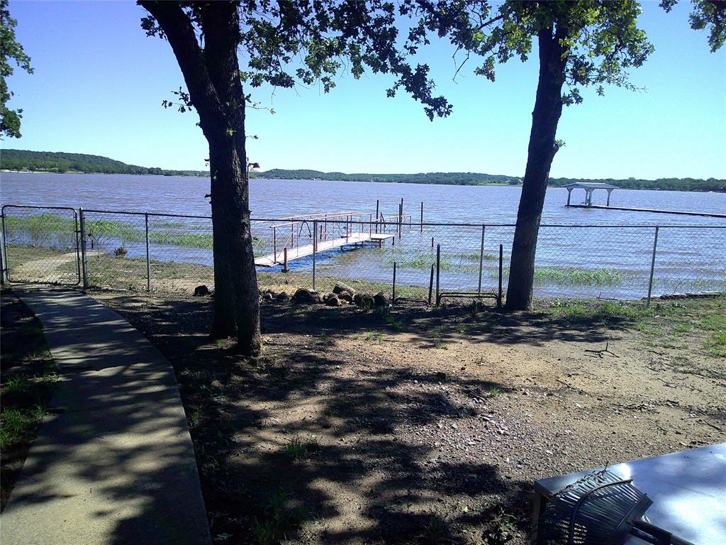 a view of a yard with wooden fence