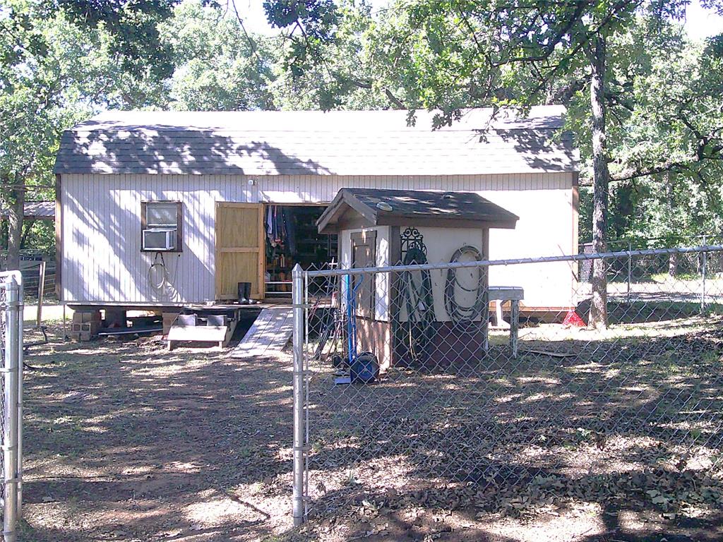 999 Roberts Cut Off Road Bowie, TX 76230 - Photo 13 of 17 a view of a house with a tree
