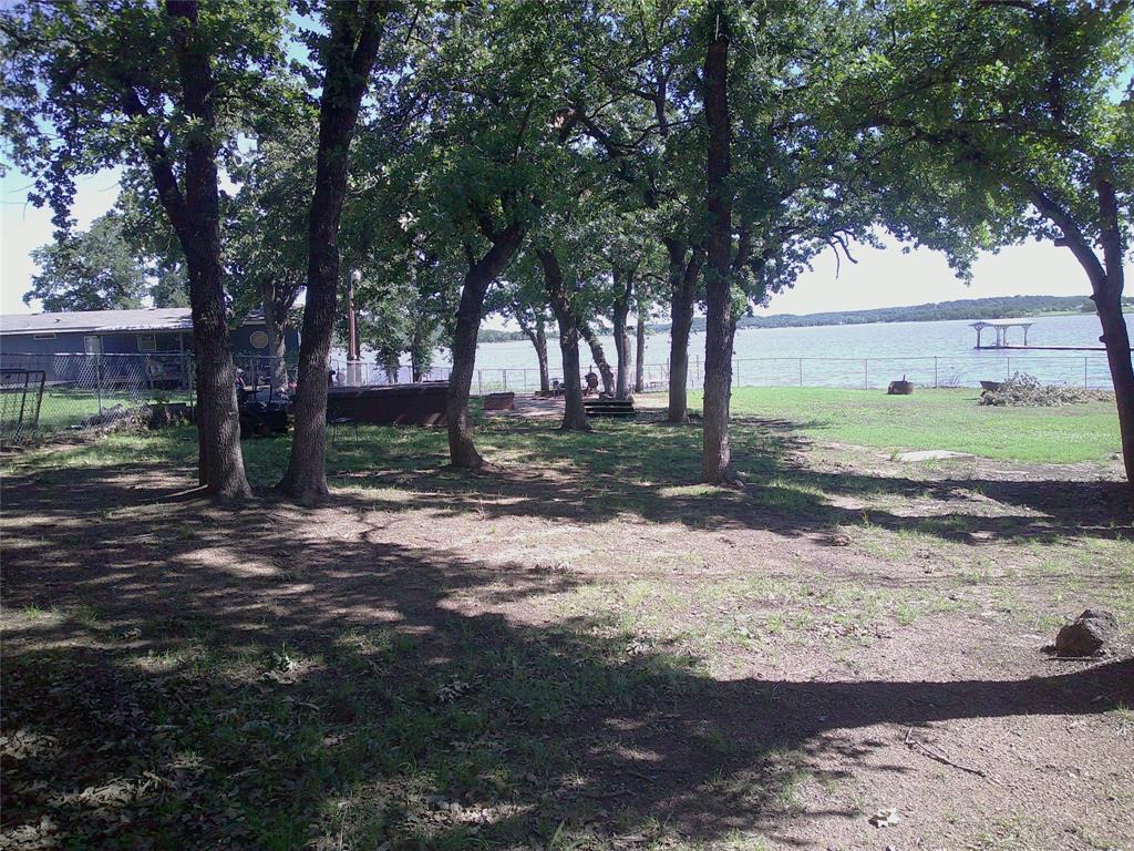 999 Roberts Cut Off Road Bowie, TX 76230 - Photo 14 of 17 a view of a yard with plants and trees