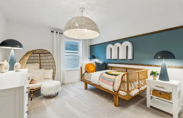 a bedroom with a bed and a chandelier