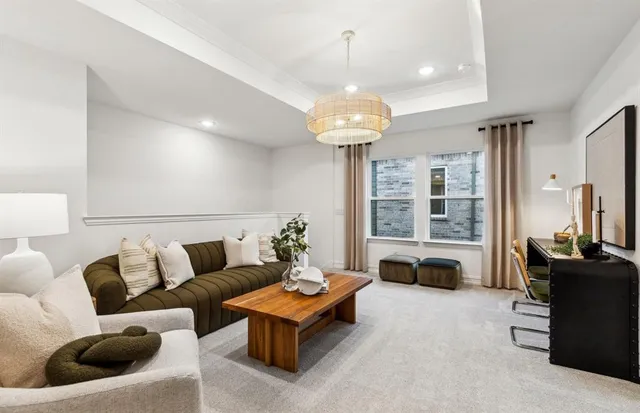 a living room with furniture and a chandelier